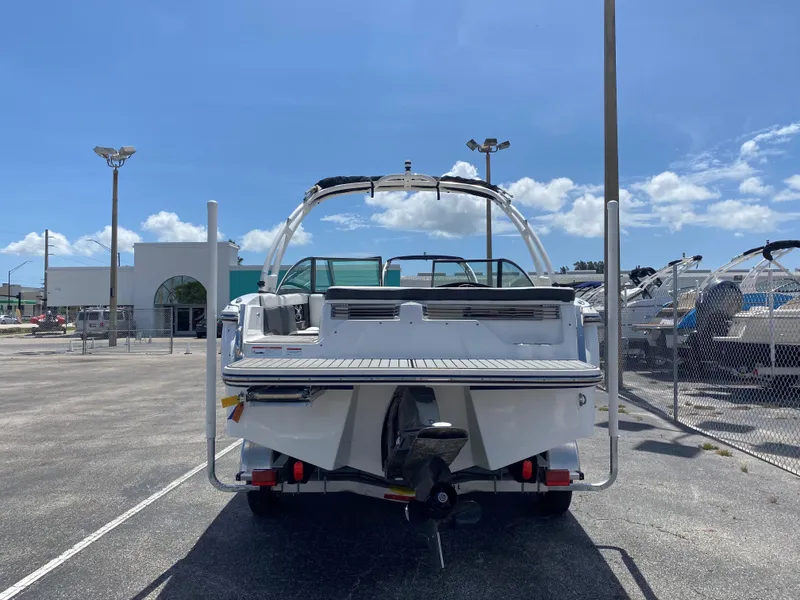 Slide: The Image of 2019 Bryant Speranza boat in a dealership lot under a clear blue sky. - 9