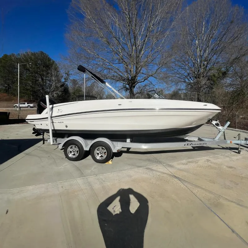 The Image of 2021 Bayliner VR6 boat with brand new Mercury engine on a trailer outside of a Boateka preowned boat dealership. - 0