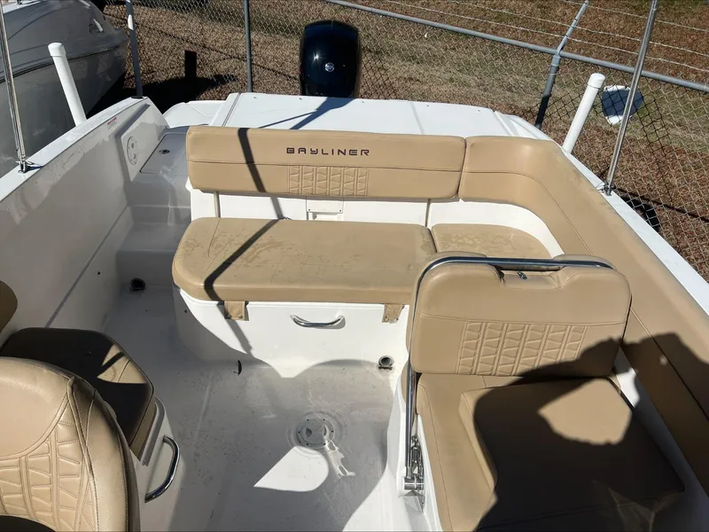 Slide: The Image of 2021 Bayliner VR6 boat interior with beige seating and white deck. - 10