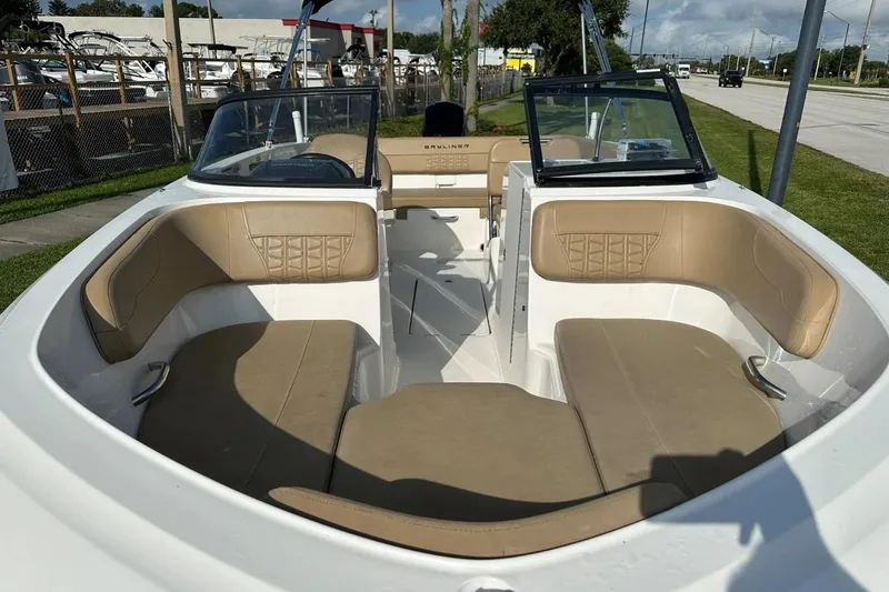 Slide: The Image of 2021 Bayliner VR6 Bowrider OB with tan seating, docked outdoors. - 15