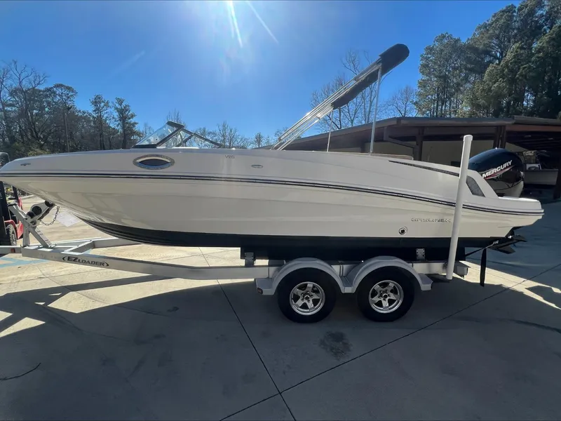 Slide: The Image of 2021 Bayliner VR6 boat on a trailer in a sunny outdoor setting. - 3