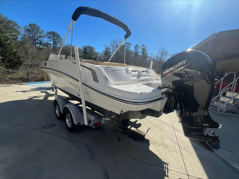 Slide: The Image of 2021 Bayliner VR6 boat with Mercury outboard motor on a trailer. - 6