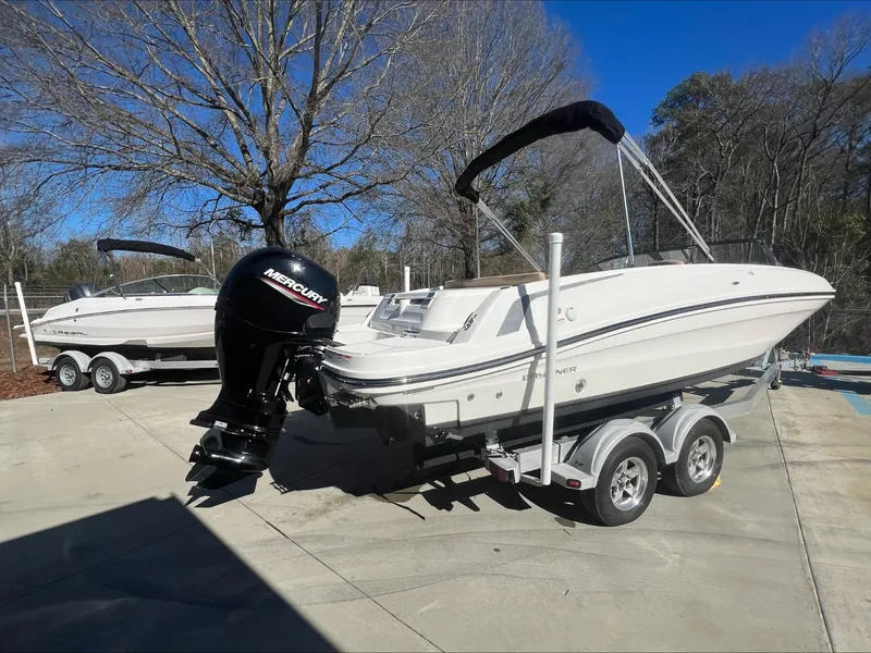 Slide: The Image of 2021 Bayliner VR6 boat on a trailer with a Mercury outboard motor. - 7