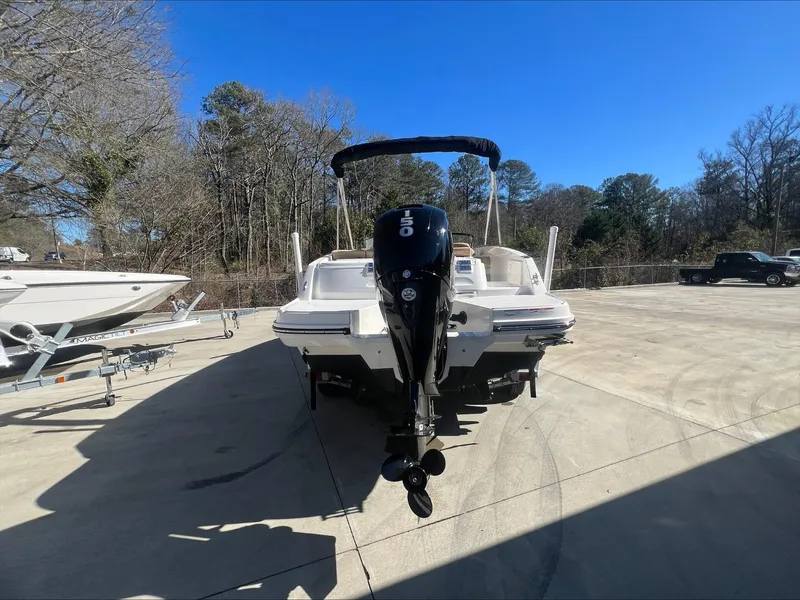 Slide: The Image of 2021 Bayliner VR6 boat with outboard motor in a parking lot. - 8