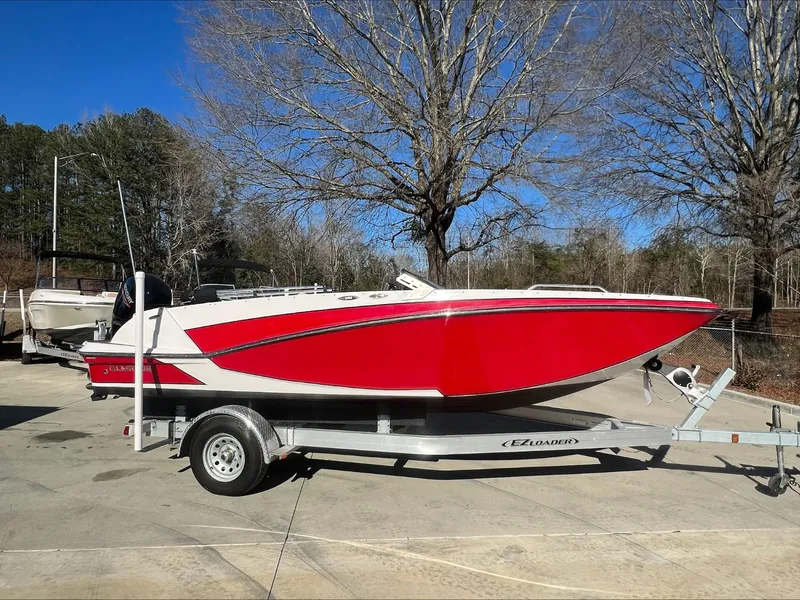 The Image of 2019 Glastron GT 200 red and white speedboat on a trailer. - 0