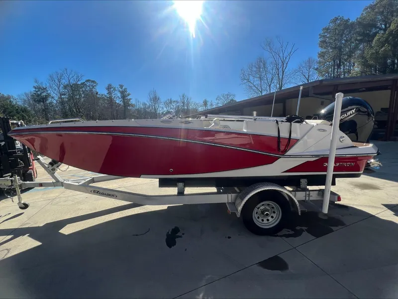 Slide: The Image of 2019 Glastron GT 200 boat on a trailer in a dealership lot. - 5