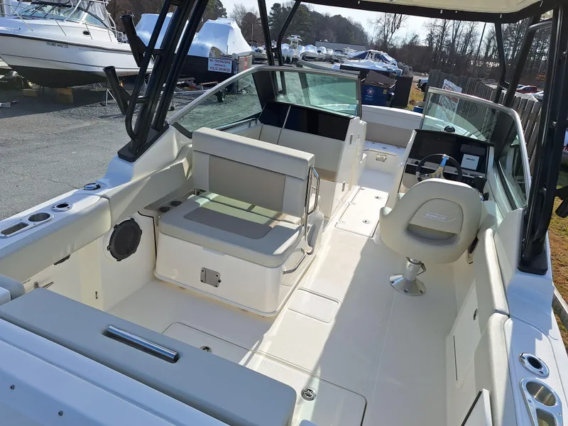 Slide: The Image of 2022 Boston Whaler 240 Vantage boat interior with seating and helm station. - 2