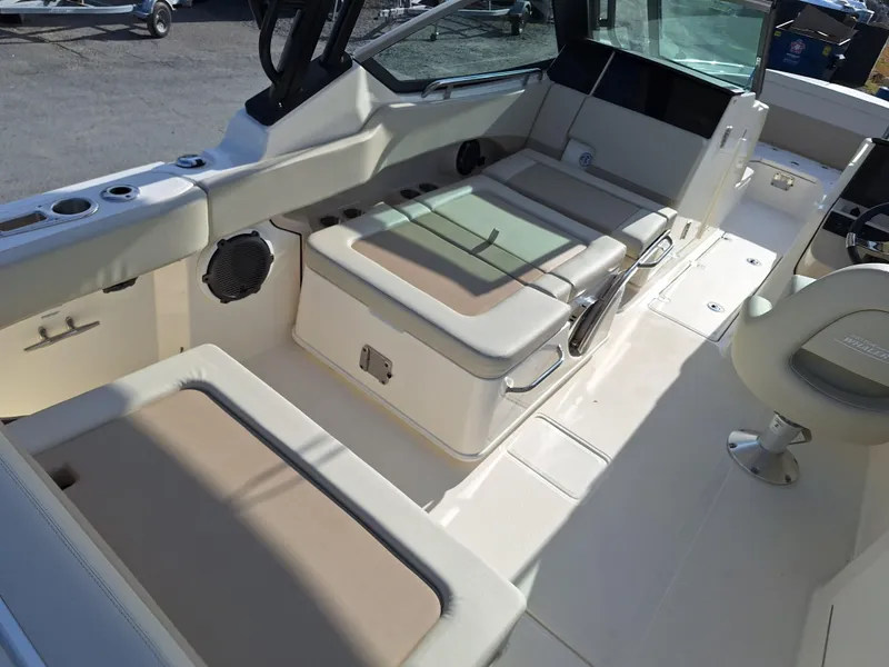 Slide: The Image of 2022 Boston Whaler 240 Vantage boat interior with beige seating and modern amenities. - 3