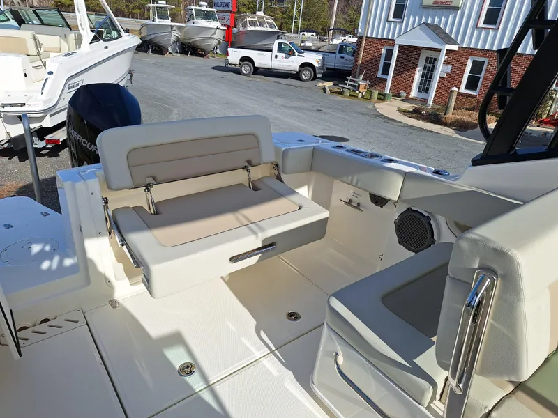 Slide: The Image of 2022 Boston Whaler 240 Vantage boat interior with seating and storage compartments. - 5