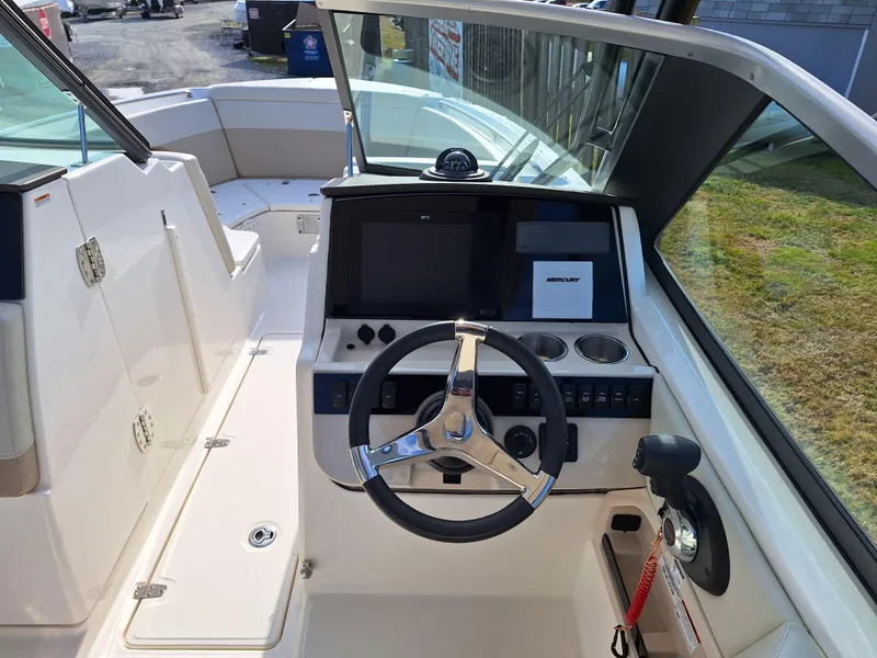 Slide: The Image of 2022 Boston Whaler 240 Vantage boat cockpit with steering wheel and control panel. - 6