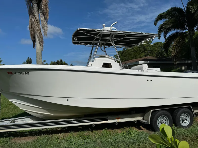 The Image of 2002 Edgewater 260 Center Console boat on trailer, parked on grass. - 0