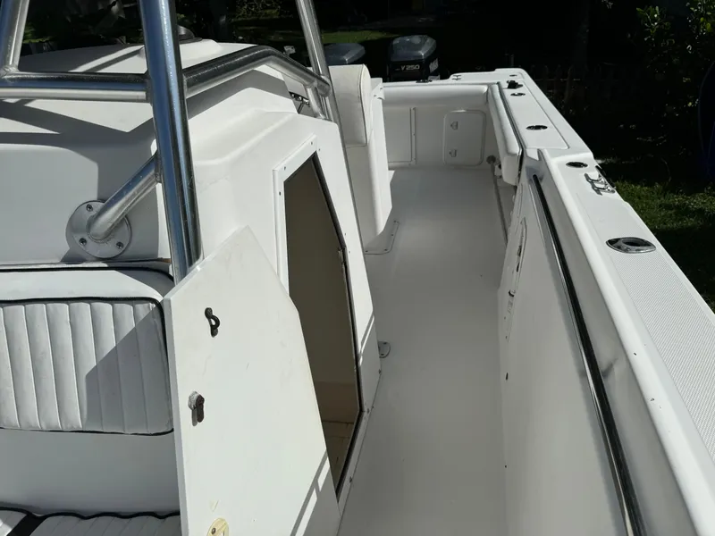 Slide: The Image of 2002 Edgewater 260 Center Console boat interior with open storage compartment. - 12