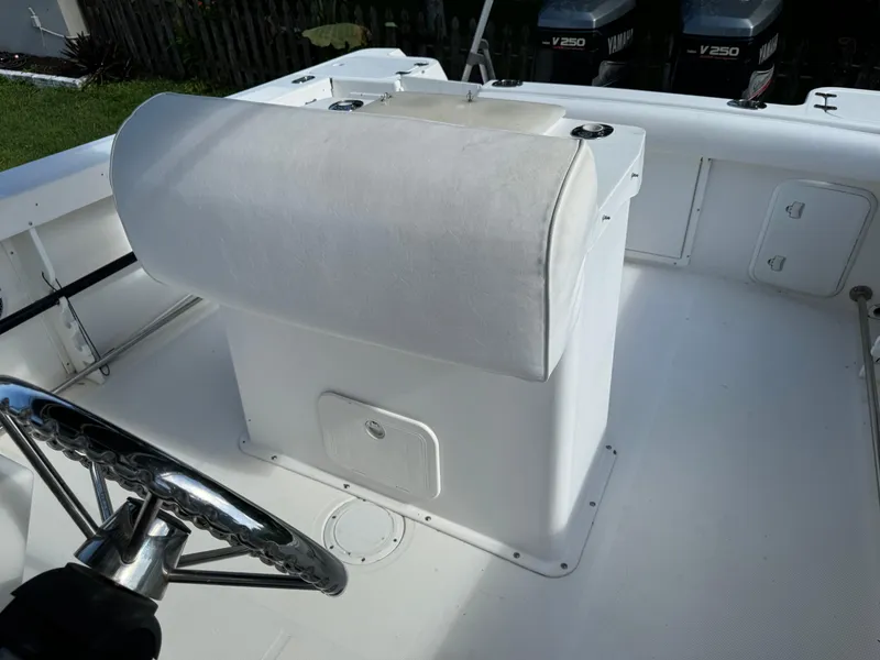 Slide: The Image of Edgewater 260 Center Console 2002 boat interior with steering wheel and seating. - 15