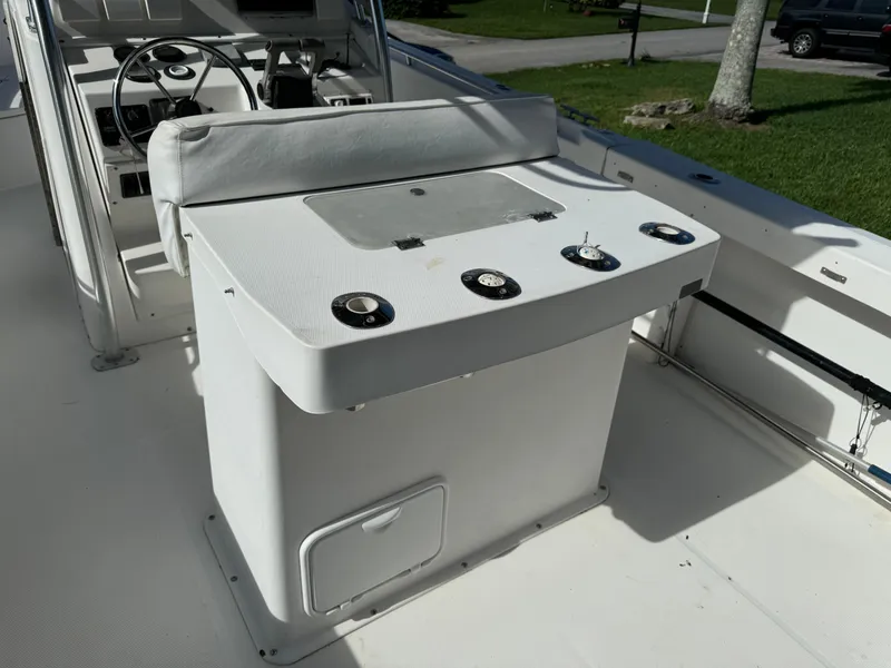 Slide: The Image of 2002 Edgewater 260 Center Console boat interior with helm and seating area. - 16