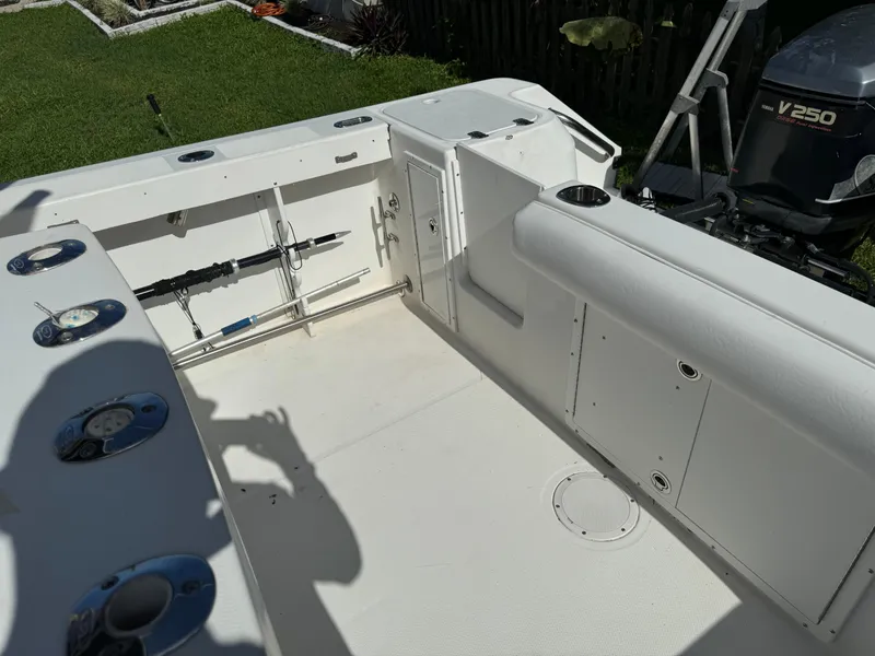 Slide: The Image of 2002 Edgewater 260 Center Console boat interior with fishing rod holders and Yamaha V250 engine. - 17