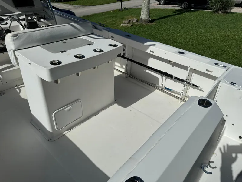 Slide: The Image of 2002 Edgewater 260 Center Console boat interior with seating and rod holders. - 20
