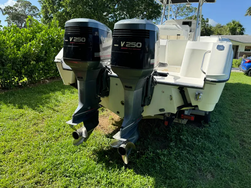 Slide: The Image of 2002 Edgewater 260 Center Console with twin V250 outboard motors on grass. - 5