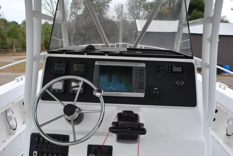 Slide: The Image of 2001 ProKat 2800KAT boat dashboard with steering wheel and navigation equipment. - 13