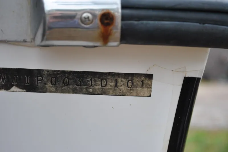 Slide: The Image of Hull identification number on a 2001 ProKat 2800KAT boat, showing slight rust and wear. - 21