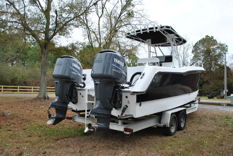 Slide: The Image of 2001 ProKat 2800KAT boat with dual Yamaha engines on a trailer, parked outdoors. - 24