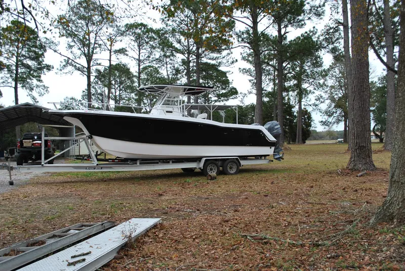 Slide: The Image of 2001 ProKat 2800KAT boat on trailer, parked in wooded area. - 25