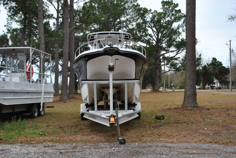 Slide: The Image of 2001 ProKat 2800KAT boat on trailer, parked in wooded area. - 3