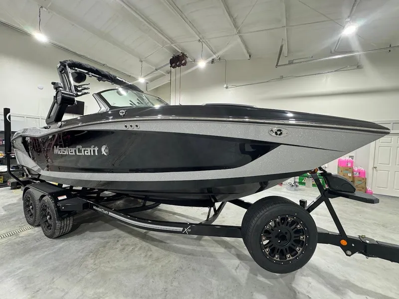 Slide: The Image of 2024 MasterCraft X22 boat in showroom on trailer. - 11