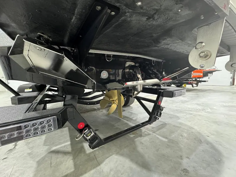 Slide: The Image of 2024 MasterCraft X22 boat underside showing propeller and trailer components. - 14