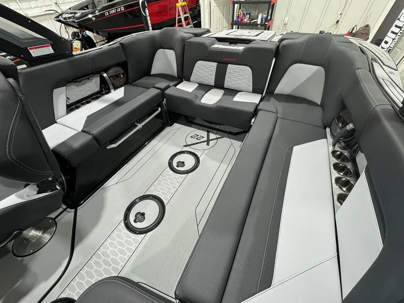 Slide: The Image of 2024 MasterCraft X22 boat interior with luxurious seating and modern design. - 18