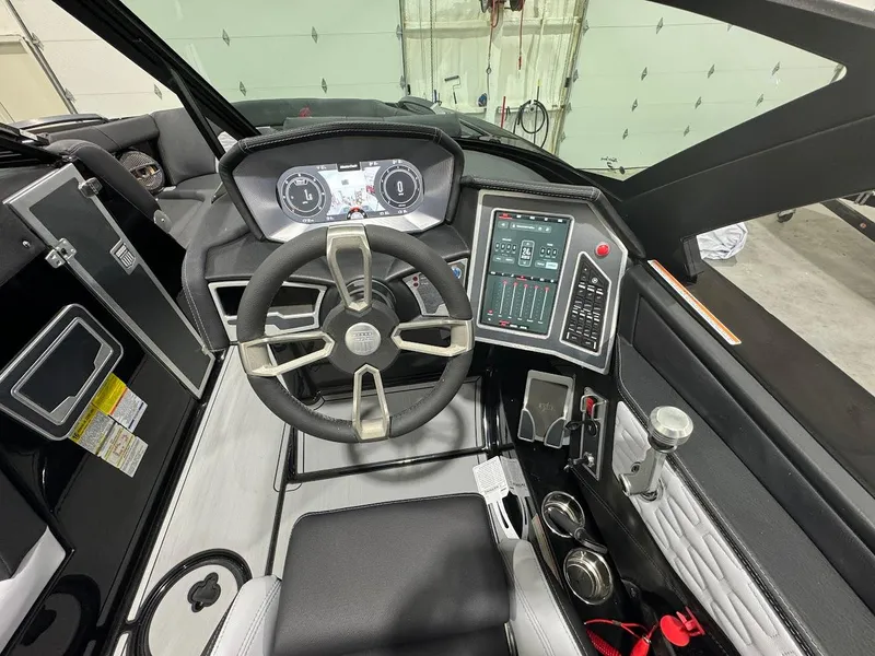 Slide: The Image of 2024 MasterCraft X22 boat cockpit with advanced controls and steering wheel. - 20