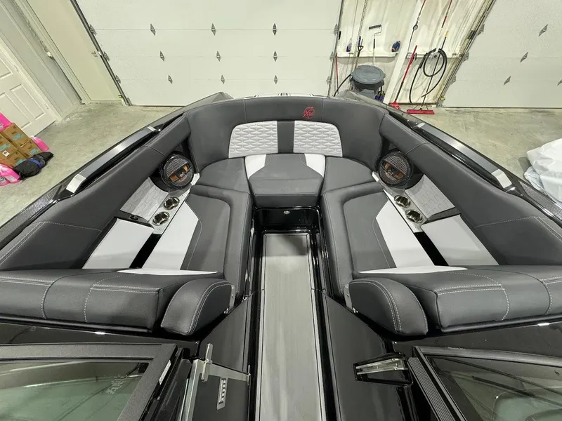 Slide: The Image of 2024 MasterCraft X22 boat interior with gray and white seating. - 21