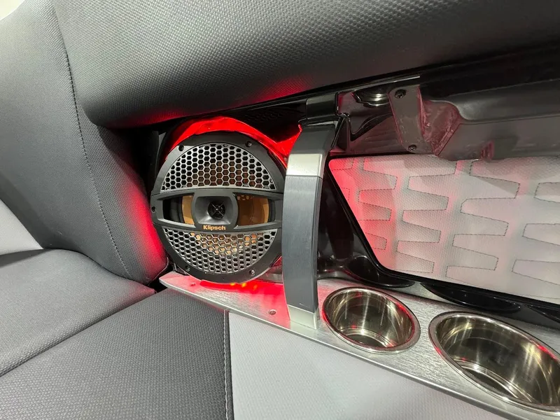 Slide: The Image of 2024 MasterCraft X22 boat interior with speaker and cup holders. - 23