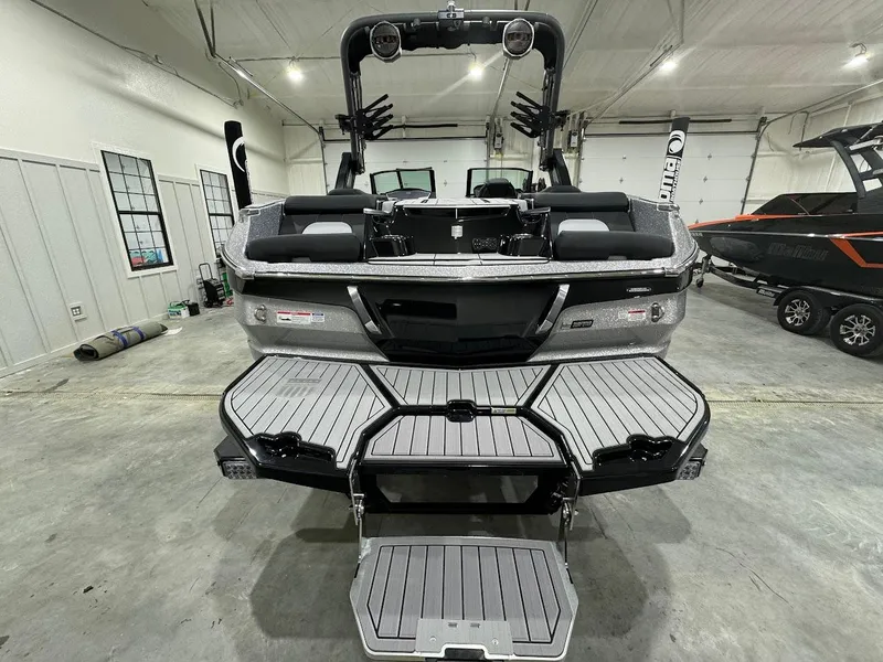 Slide: The Image of 2024 MasterCraft X22 boat rear view in a showroom. - 8