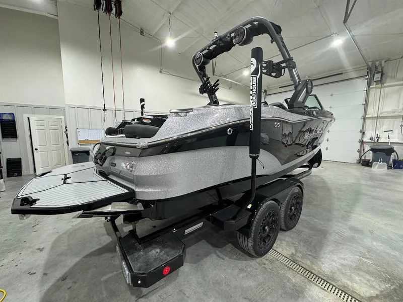 Slide: The Image of 2024 MasterCraft X22 boat in a garage on a trailer. - 9