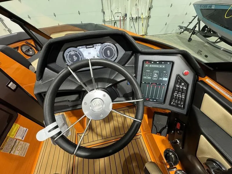Slide: The Image of 2024 MasterCraft XStar S dashboard with steering wheel and control panel. - 10