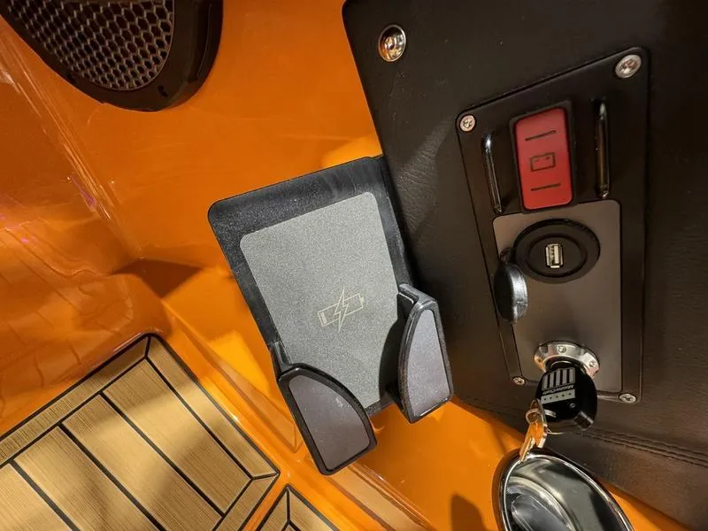 Slide: The Image of 2024 MasterCraft XStar S dashboard with key ignition and phone holder. - 11