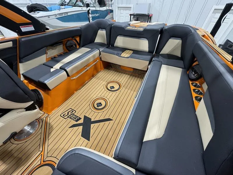Slide: The Image of 2024 MasterCraft XStar S boat interior with luxurious seating and teak flooring. - 14
