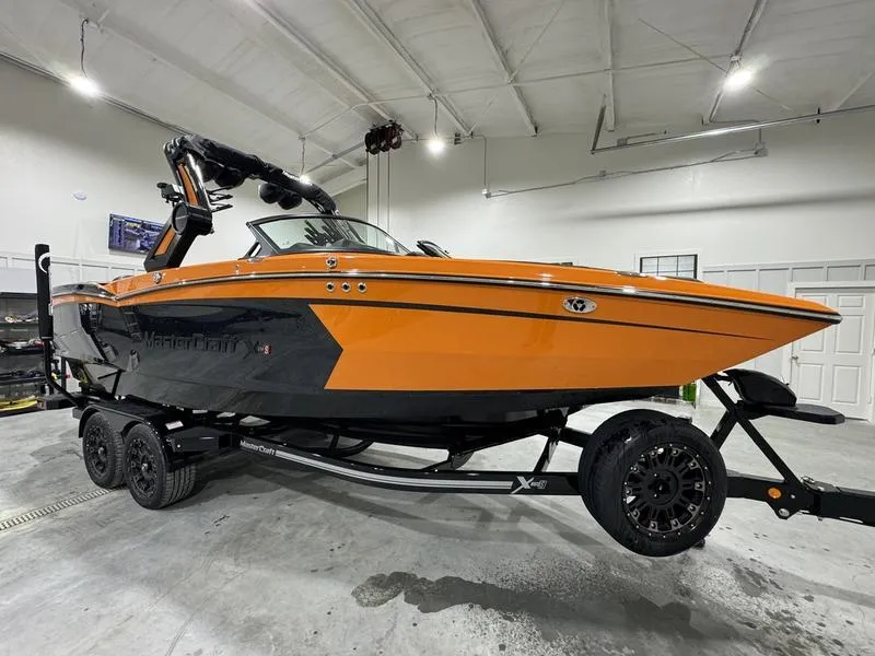 Slide: The Image of 2024 MasterCraft XStar S boat in an indoor showroom. - 4