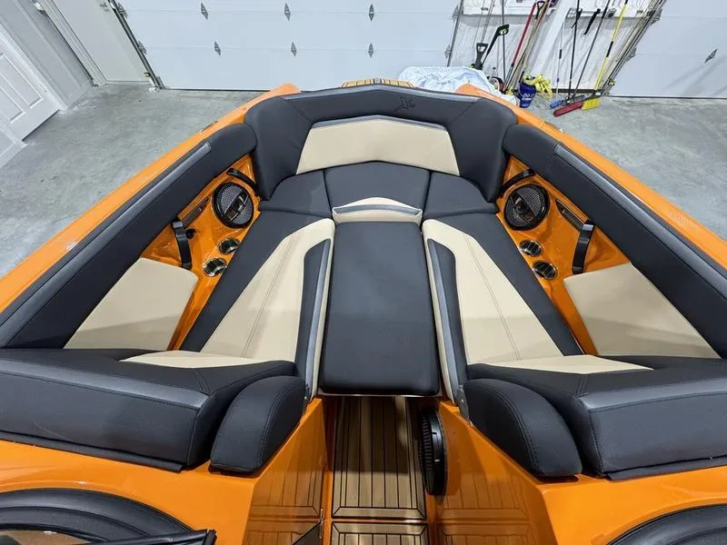 Slide: The Image of 2024 MasterCraft XStar S boat interior with orange and black seating. - 9
