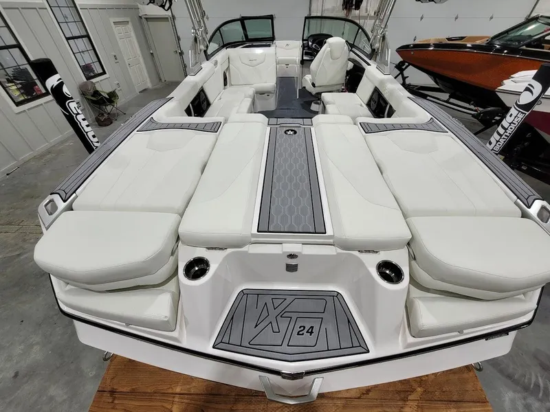 Slide: The Image of 2024 MasterCraft XT24 boat interior with white seating and modern design. - 15