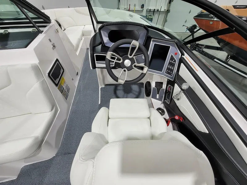 Slide: The Image of 2024 MasterCraft XT24 boat interior with modern dashboard and white leather seats. - 20