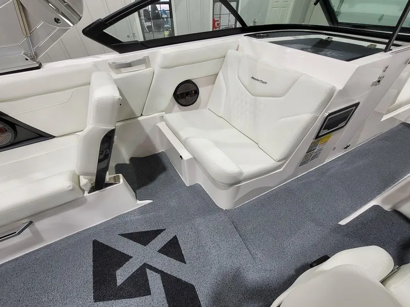 Slide: The Image of 2024 MasterCraft XT24 boat interior with white leather seats and grey carpet. - 21