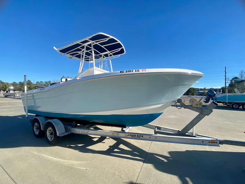 Slide: The Image of 2016 Clearwater 2200CC boat on a trailer under a clear blue sky. - 1