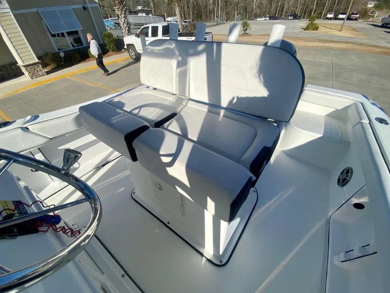 Slide: The Image of 2016 Clearwater 2200CC boat interior with white seating and steering wheel. - 11