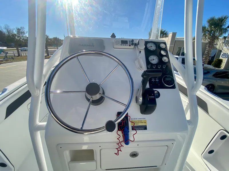 Slide: The Image of 2016 Clearwater 2200CC boat console with steering wheel and gauges. - 14