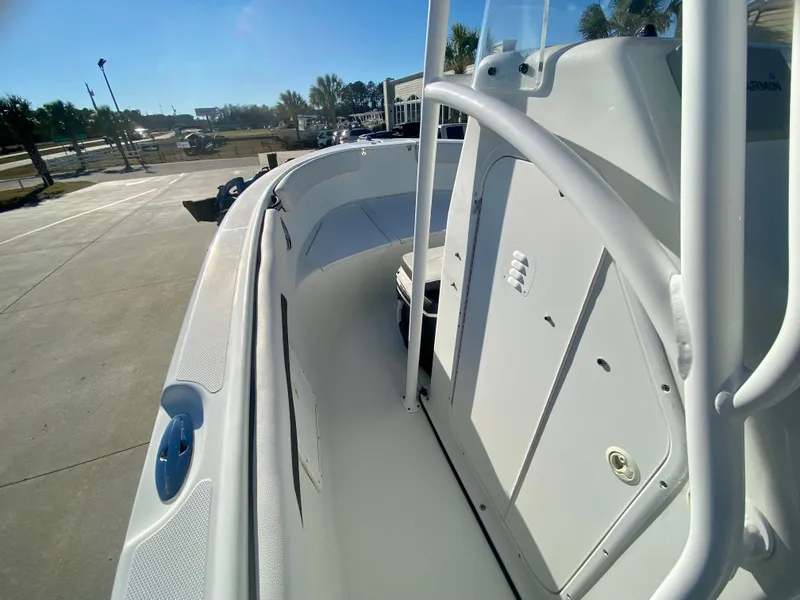 Slide: The Image of 2016 Clearwater 2200CC boat, side view of deck and console in a marina. - 15