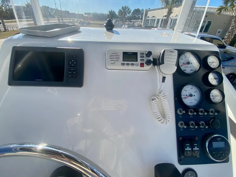 Slide: The Image of 2016 Clearwater 2200CC boat dashboard with gauges, GPS, and radio. - 16