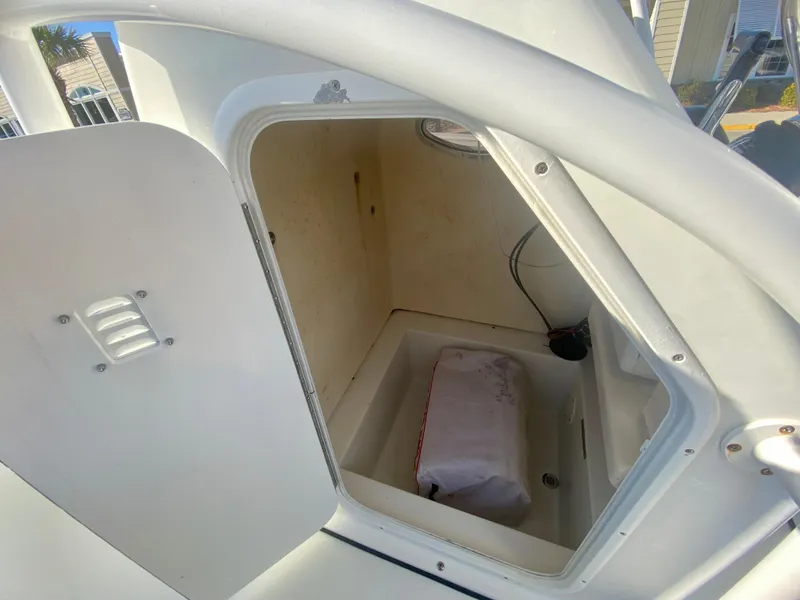 Slide: The Image of Open storage compartment on a 2016 Clearwater 2200CC boat. - 17