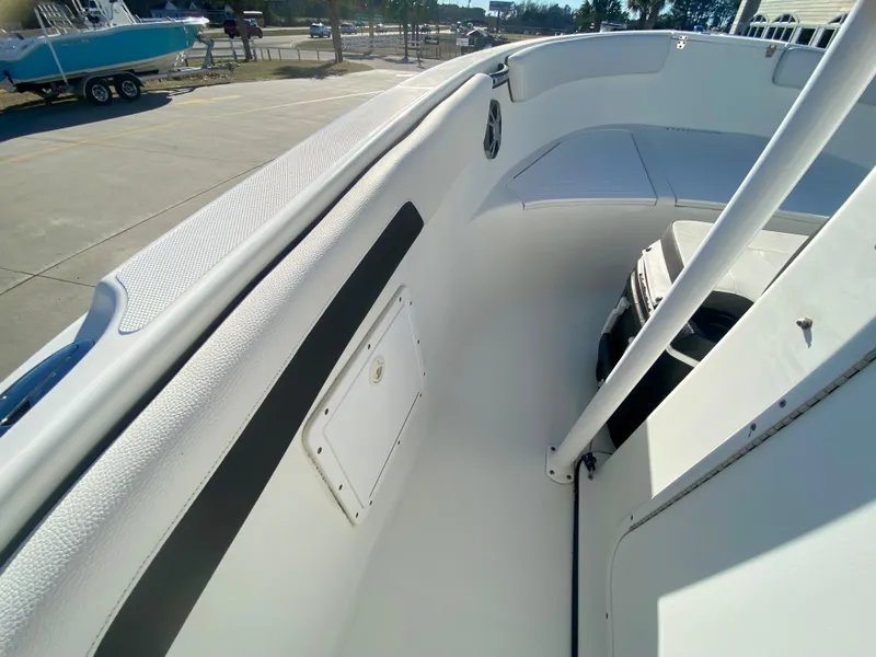 Slide: The Image of 2016 Clearwater 2200CC boat interior, white deck and seating area. - 18