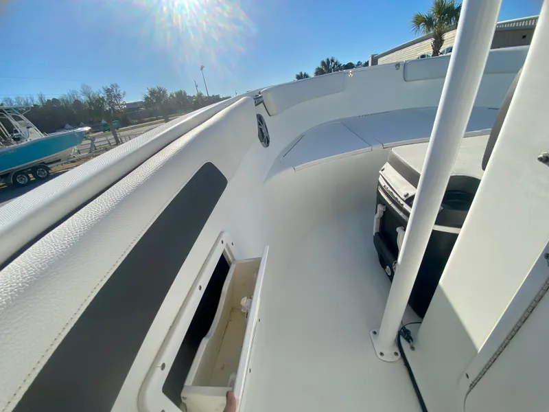 Slide: The Image of 2016 Clearwater 2200CC boat interior with storage compartment and seating. - 19